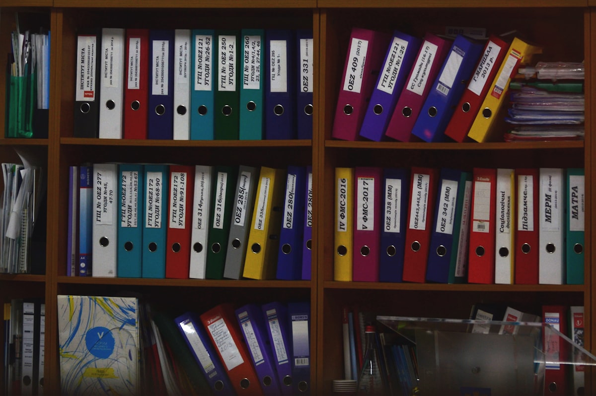 Labeled binders neatly organized on a shelf, representing well-sorted directory categories